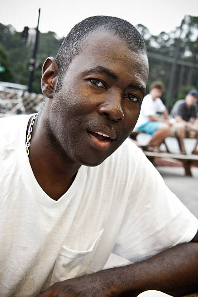 Man sits outside at a restaurant or park stock photo