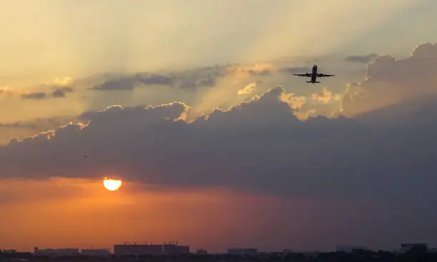 Passenger airplane taking-off from Tan Son Nhat Airport (SGN) in sunset.