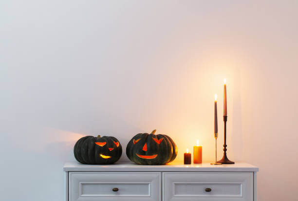 istock black halloween pumpkin with burning candles in white interior 1505434581