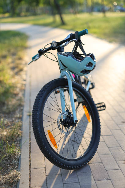 istock A bicycle with a helmet stands on a cycle path in the park. 1505478119