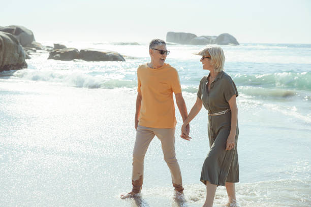 istock Affectionate senior couple on the beach holding hands 1505481378
