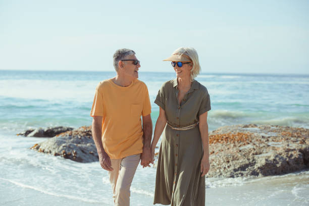 istock Affectionate senior couple on the beach holding hands 1505481401