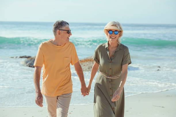 istock Affectionate senior couple on the beach holding hands 1505481942