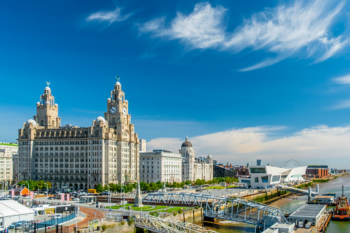 Liverpool city skyline, waterfront and the three graces (The Royal Liver, the Cunard and the Port of Liverpool Buildings) on the River Mersey in North West England, UK.