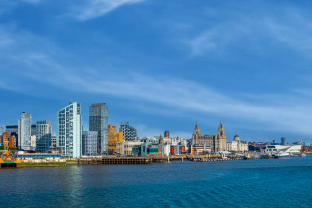 Liverpool city skyline, waterfront and the three graces (The Royal Liver, the Cunard and the Port of Liverpool Buildings) on the River Mersey in North West England, UK.