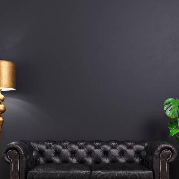 Cozy retro-chic interior with a black leather cushion sofa, a retro golden electric lamp, and a potted plant (monstera) in front of a black wall background with a large picture frame with passe-par-tout and copy space. A waiting room like a doctor's or lawyer's office. A slight vintage effect was added. 3D rendered image.