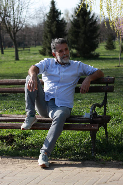 istock Mature man relaxing on bench enjoy in sunny day 1505543905