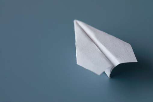 Paper airplane on blue background.