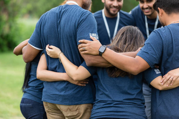 istock Diverse group of people stand close together in prayer 1505560732