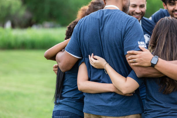 istock Unrecognizeable people stand together in a huddle at the park 1505560743