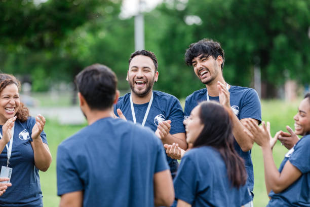 Multiracial group of volunteers smile and clap