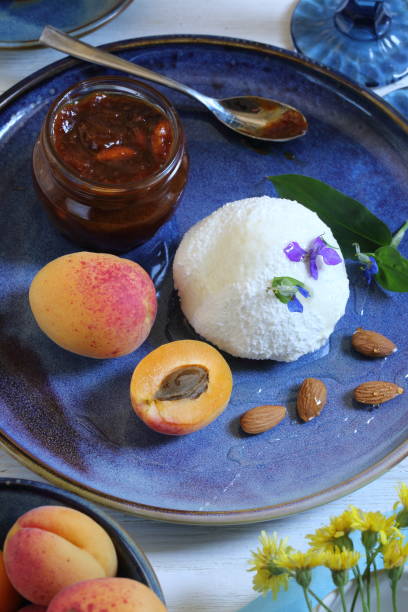 istock Cottage cheese with apricots on a blue plate 1505585111