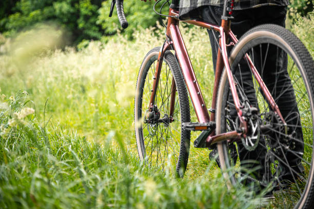 istock A man with a bicycle in the forest among the grass. 1505593654