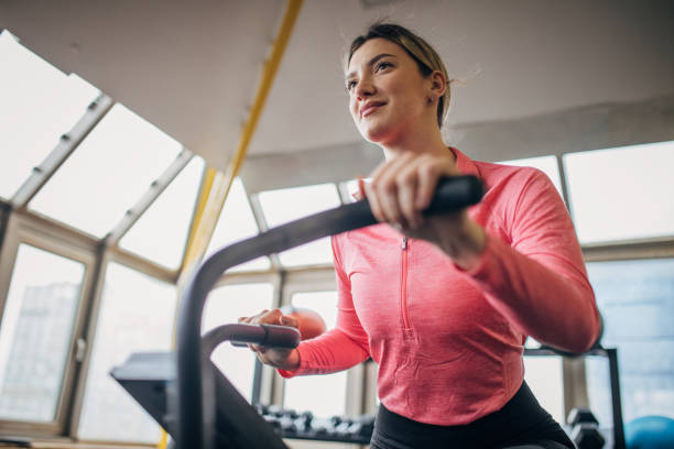 istock Woman exercising on exercise bike 1505593771
