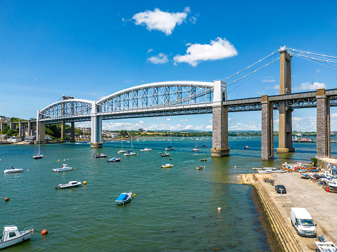 Plymouth, UK. 29 June 2023. Boats under the Royal Albert Bridge on the River Tamar, designed by Isambard Kingdom Brunel, built in 1859.