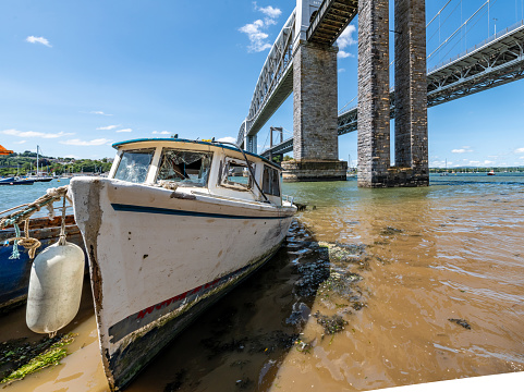 Plymouth, UK. 29 June 2023. Derelict boats by the Tamar Bridges