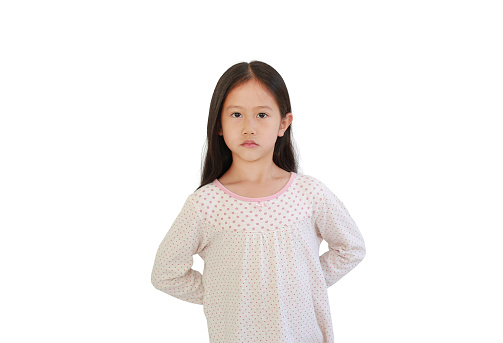 Asian little child girl hides his hands behind his back isolated on white background.