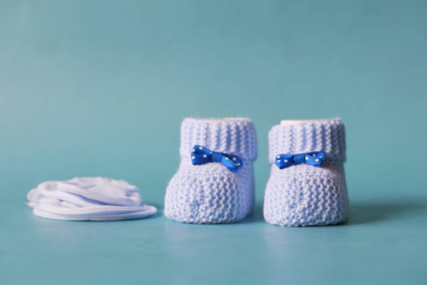 istock blue color Knitted shoes for an infant. 1505599450