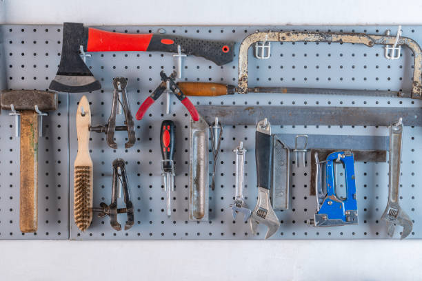 istock Work tools hanging on steel wall as background in workshop, closeup 1505628768