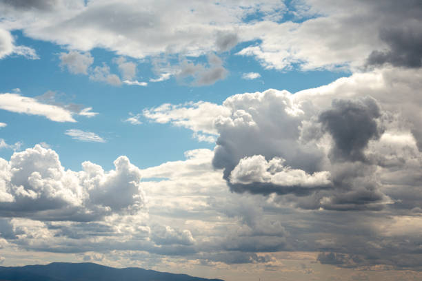 large clouds of different shapes against a blue sky background. High quality photo