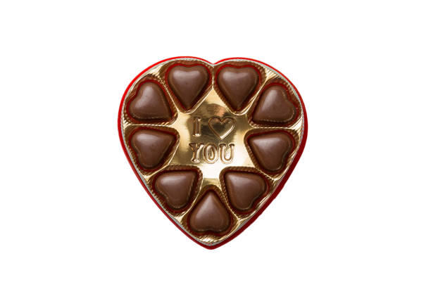 istock Chocolate candy in a box with a colored bow. Gift box with Chocolates isolated on white top view 1505641592