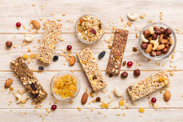 istock Various granola bars on table background. Cereal granola bars. Superfood breakfast bars with oats, nuts and berries, close up. Superfood concept 1505641793