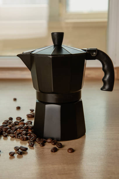 istock Moka pot on the kitchen table. Geyser coffee maker on brown texture background. Morning concept. Morning coffee.Space for copy. Place for text. 1505642348