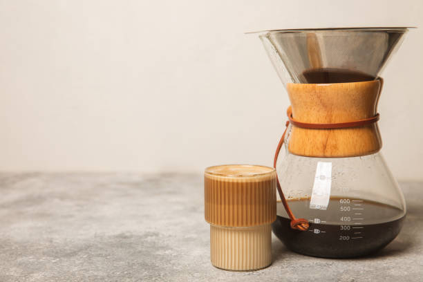 istock Preparing coffee using Chemex, pour coffee maker and drip kettle. Alternative ways to brew coffee.Coffee shop concept.Creamy latte with cream. Vanilla raf. 1505642827
