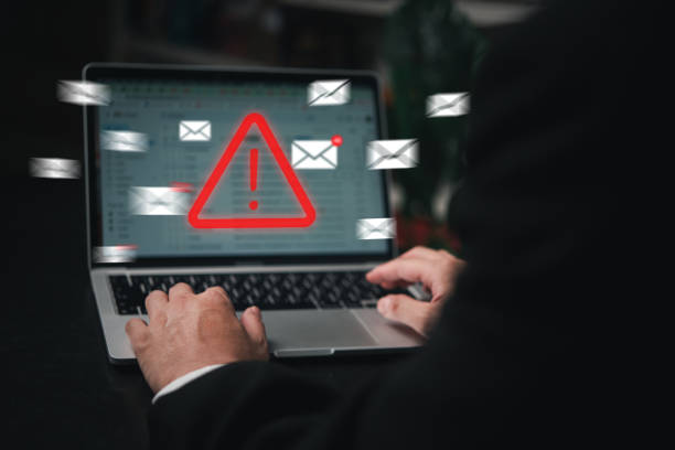 istock Man using laptop computer with hacker alarm protecting data from cybercrime in the digital age. Internet security and privacy defending against data theft and email breach. 1505655723