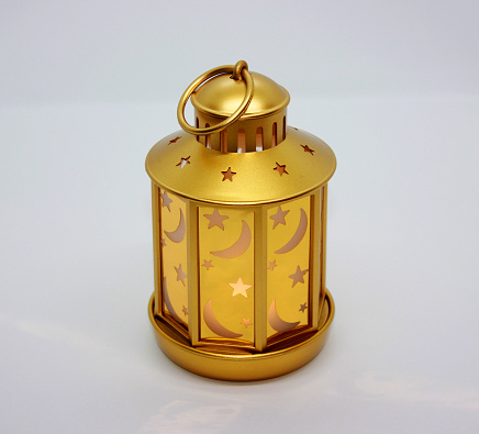 Beautiful small LED lantern on a white background.  Lantern decorated with night sky with stars.