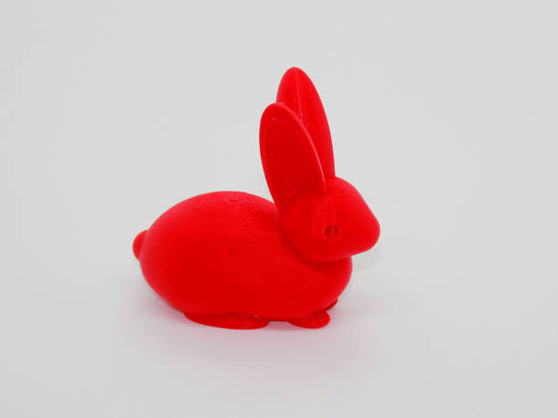 Rabbit 3D model created by a 3D printer. Red Rabbit sculpture. Realistic toy of a Rabbit. Red Rabbit Statue on white background. Creative concept. stock photo
