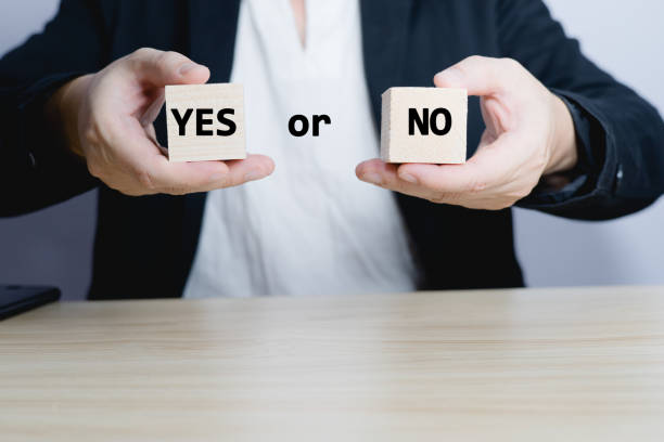istock businessman is selecting a block that has the word yes or no on it. deciding Think with yes or no options. Business options for difficult situations yes or no. 1505668152