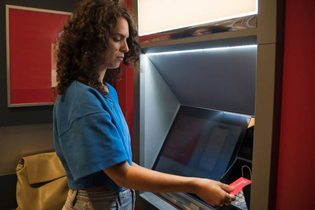 istock Woman making a transaction at an ATM machine. 1505670619