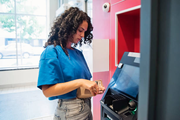 istock Woman making a transaction at an ATM machine. 1505670907