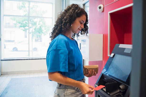 Woman making a transaction at an ATM machine.