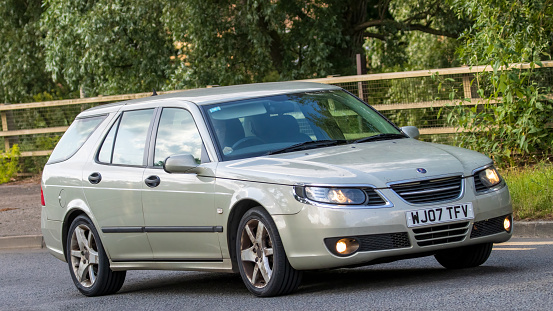 Milton Keynes,UK - June 24th 2023. 2007 SAAB 9-5 LINEAR SPORT TID estate car travelling on an English country road