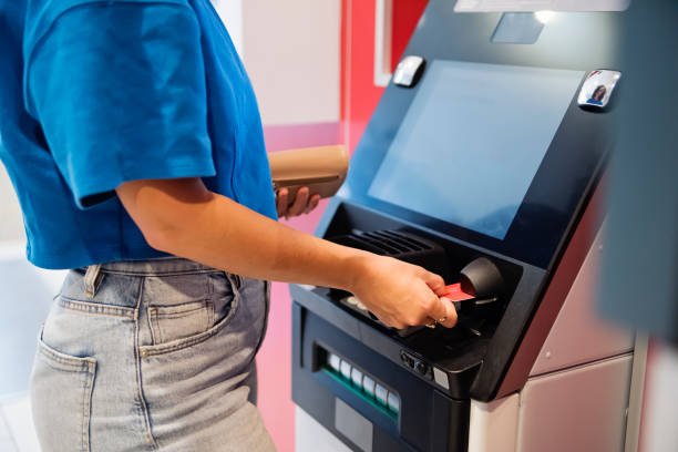 istock Close-up on woman's hand making a transaction at an ATM machine. 1505671503