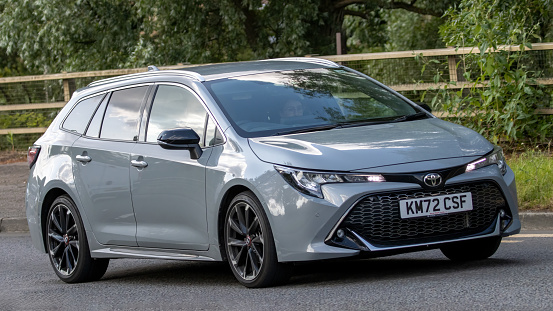 Milton Keynes,UK - June 24th 2023. 2022 TOYOTA COROLLA GR SPORT HEV CVT hybrid electric car travelling on an English country road