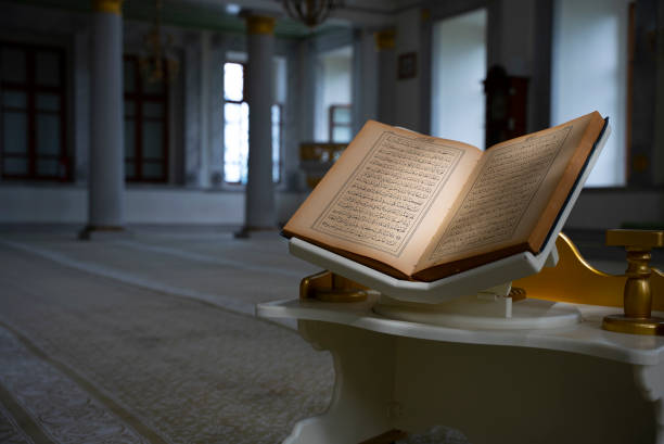 close-up of holy book Quran at the mosque close-up of holy book Quran, sunlight is reflected to Quran religious text stock pictures, royalty-free photos & images