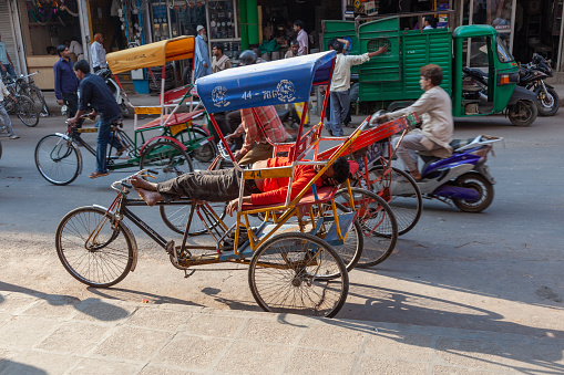 New Delhi, India - November 17, 2011: rickshaw driver at Meena Bazaar in Chandni Chowk is sleeping and takes a rest.
