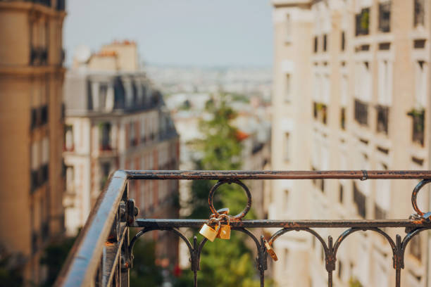 Love locks in Montmartre and unfocused view of Paris rooftops. A love lock or love padlock is a padlock that couples lock to a bridge, fence, gate, monument, or similar public fixture to symbolize their love. Typically the sweethearts' names or initials, and perhaps the date, are inscribed on the padlock, and its key is thrown away (often into a nearby river) to symbolize unbreakable love.