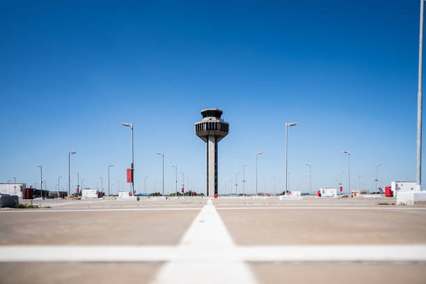 istock Empty parking lot with the airport control tower on the background 1505709172