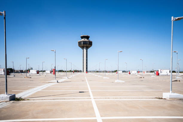 Empty parking lot with the airport control tower on the background