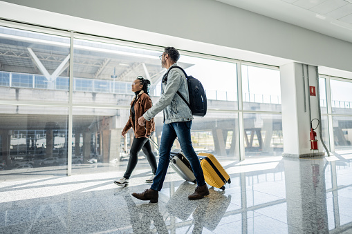 Friends walking and talking at the airport