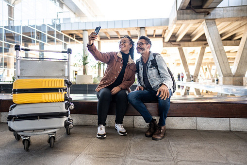 Friends taking a selfie at the airport