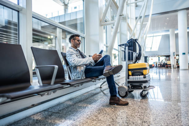 istock Mature man using mobile phone in waiting room at the airport 1505723721