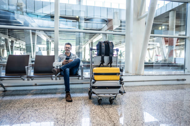 istock Mature man using mobile phone in waiting room at the airport 1505724232