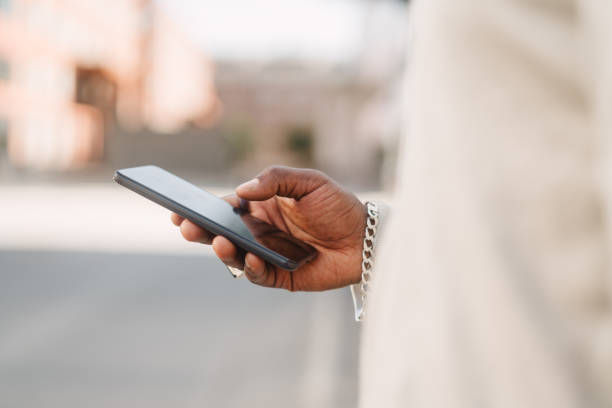 istock Young entrepreneur using a smartphone, holding the phone with his right hand 1505730374