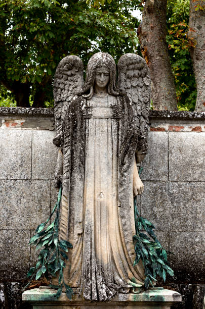 istock sorrowful angel holding two green branches 1505739528