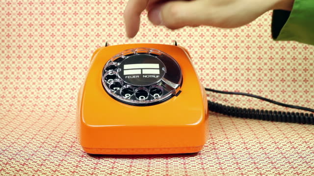 old orange telephone - dial phone number